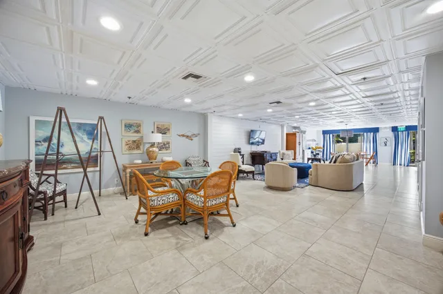 a living room with furniture a dining table and a bookshelf
