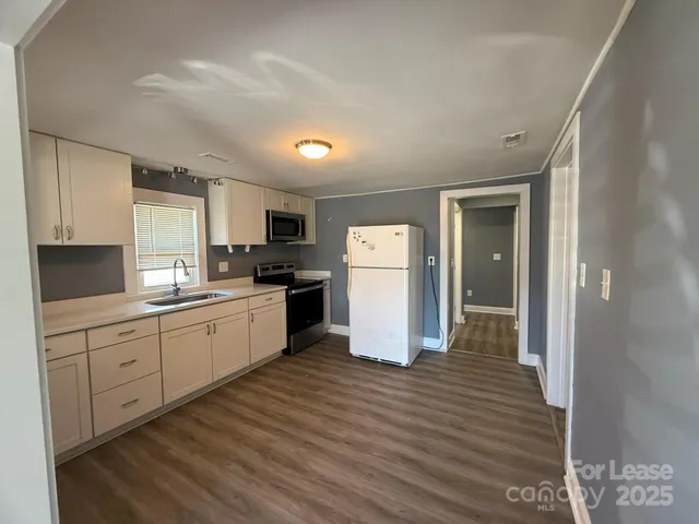 a kitchen with refrigerator and cabinets