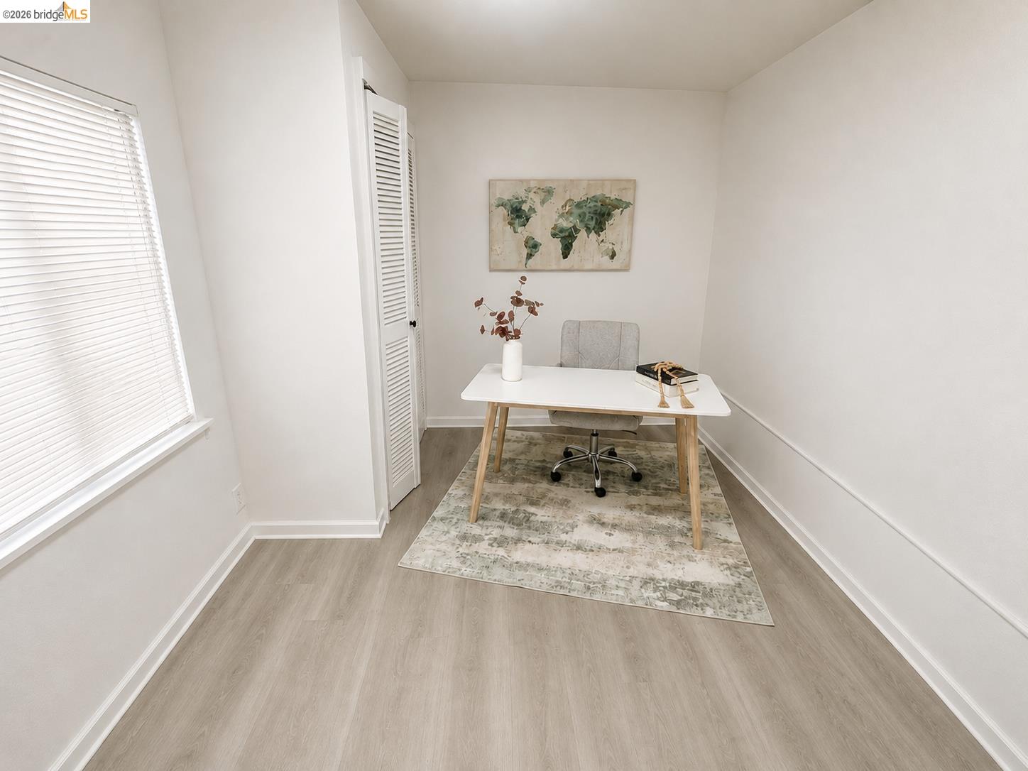 810 Pierce Street Albany, CA 94706 - Photo 15 of 25 Bright room featuring wood-finish flooring, a window with blinds, and a louvered bifold door