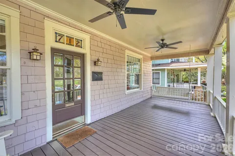 a view of a porch with wooden floor and a floor to ceiling window
