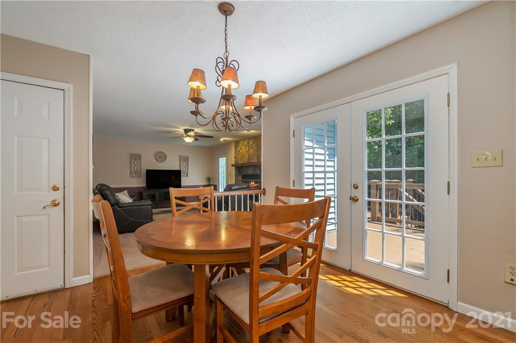 163 Fairforest Drive Rutherfordton, NC 28139 - Photo 15 of 48 a dining room with furniture a chandelier and wooden floor