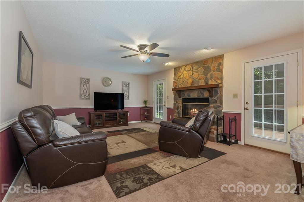 163 Fairforest Drive Rutherfordton, NC 28139 - Photo 16 of 48 a living room with furniture a fireplace and a flat screen tv