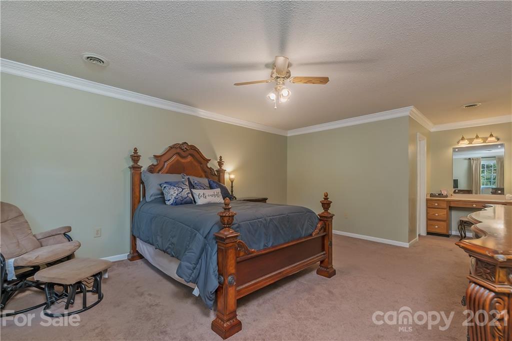 163 Fairforest Drive Rutherfordton, NC 28139 - Photo 19 of 48 a bedroom with a bed and a chandelier