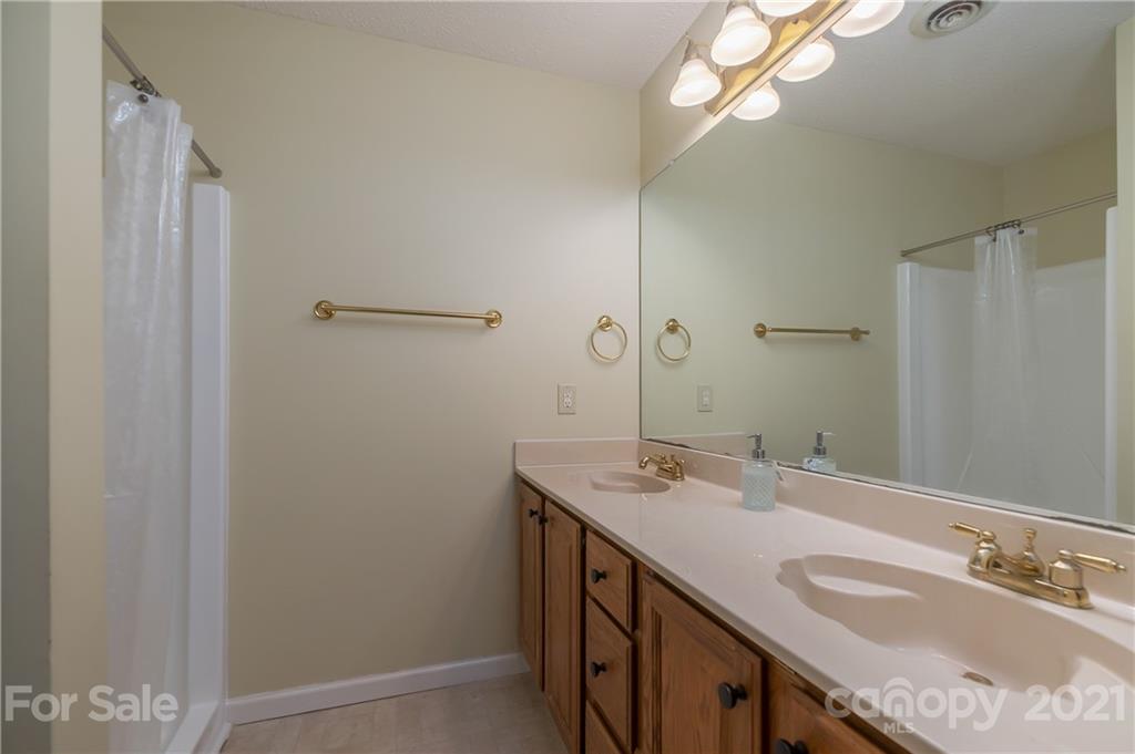 163 Fairforest Drive Rutherfordton, NC 28139 - Photo 21 of 48 a bathroom with a sink a vanity and a mirror