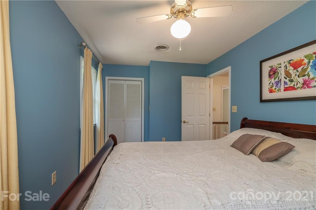 163 Fairforest Drive Rutherfordton, NC 28139 - Photo 22 of 48 a bedroom with a large bed and a chandelier