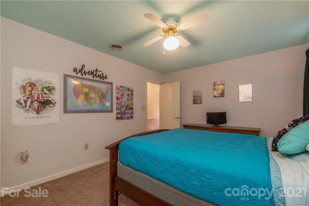 163 Fairforest Drive Rutherfordton, NC 28139 - Photo 25 of 48 a bedroom with a bed and a chandelier