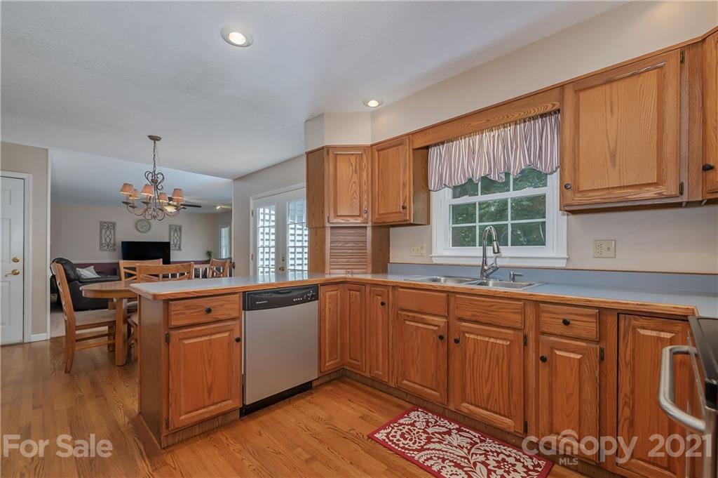 163 Fairforest Drive Rutherfordton, NC 28139 - Photo 6 of 48 a kitchen with stainless steel appliances granite countertop a stove top oven a sink dishwasher and cabinets with wooden floor