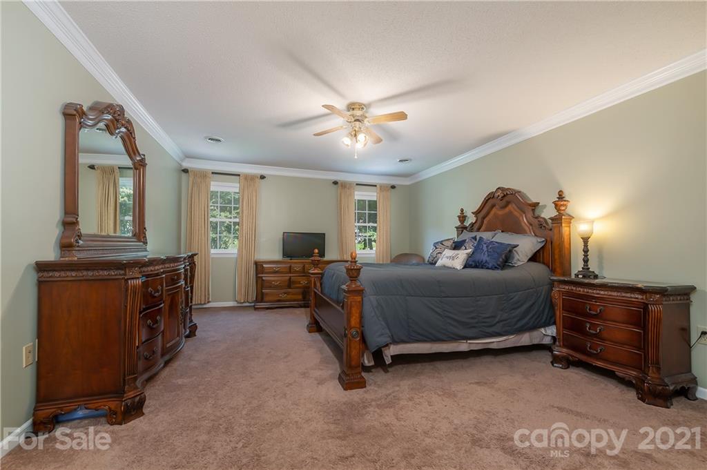 163 Fairforest Drive Rutherfordton, NC 28139 - Photo 9 of 48 a bedroom with a bed and a chandelier
