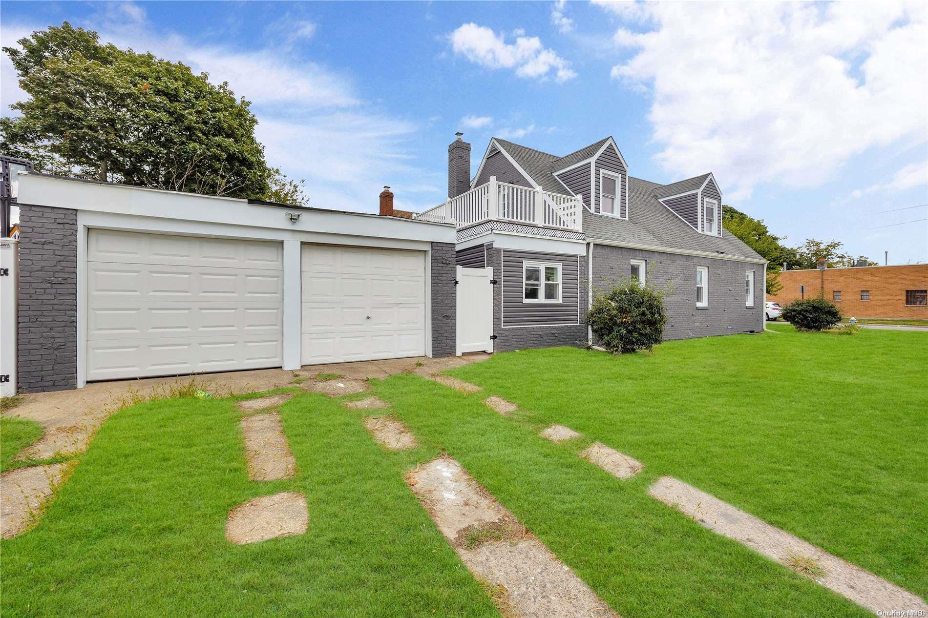 3 Booth Street Hempstead, NY 11550 - Photo 1 of 1 a front view of a house with a garden and plants
