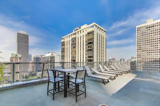 a view of balcony with two chairs and a table