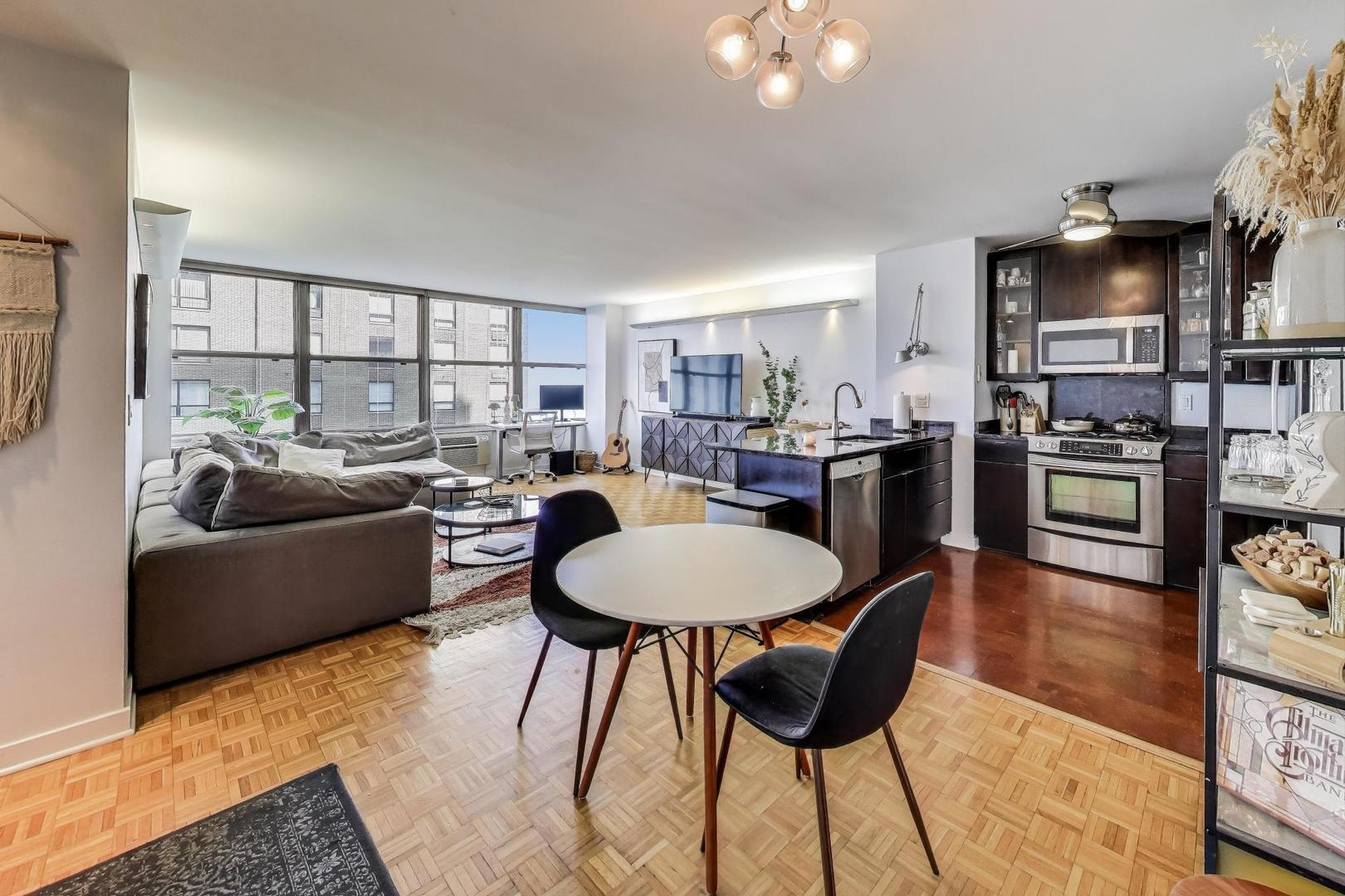 1000 North Lake Shore Plaza, Unit 804 Chicago, IL 60611 - Photo 8 of 25 a living room with furniture a fireplace and a flat screen tv