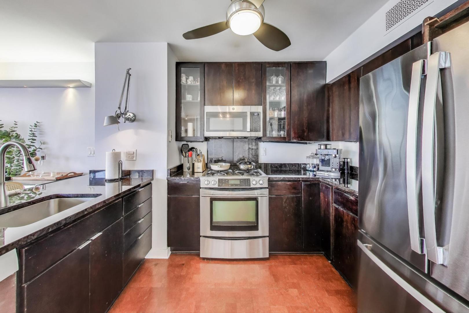 1000 North Lake Shore Plaza, Unit 804 Chicago, IL 60611 - Photo 9 of 25 a kitchen with stainless steel appliances granite countertop a sink stove and refrigerator