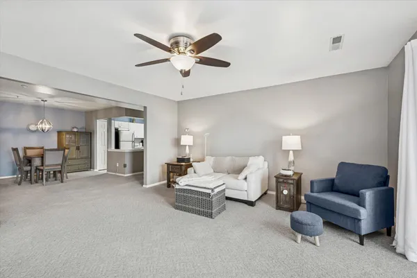 a living room with furniture and a chandelier
