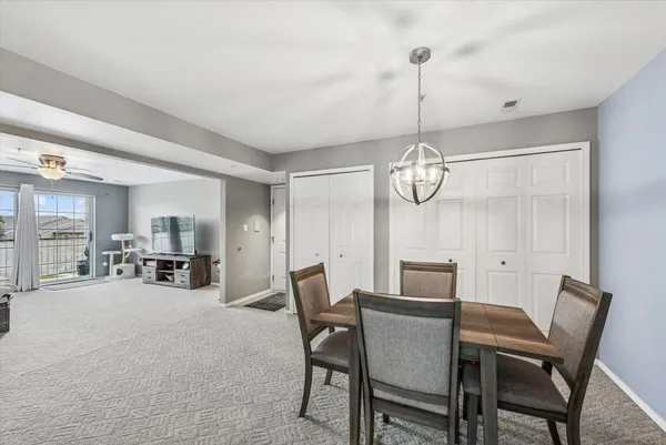 a kitchen with a sink dishwasher and white cabinets with wooden floor