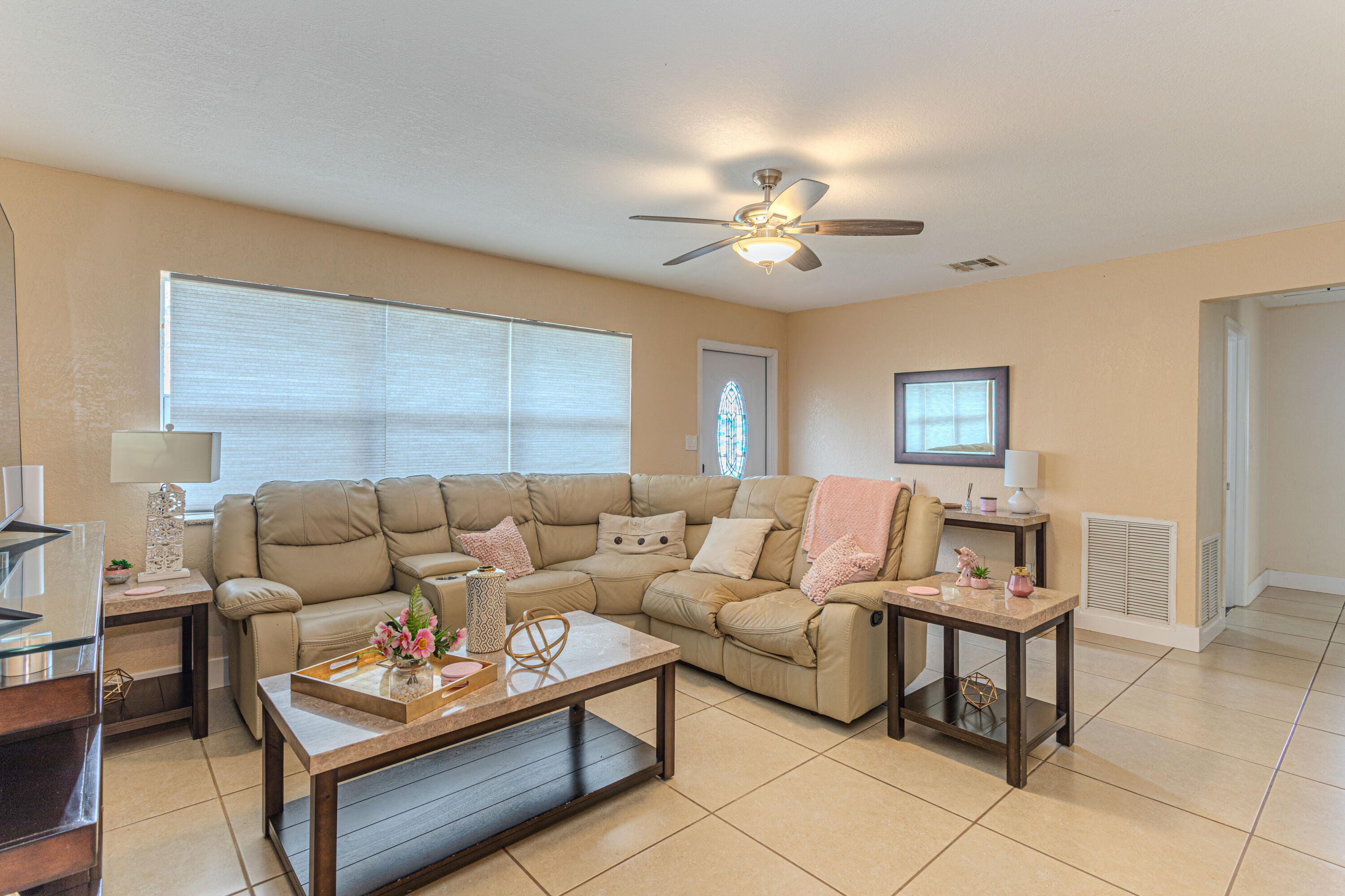 740 Aspen Road West Palm Beach, FL 33409 - Photo 11 of 34 a living room with furniture a rug and a window