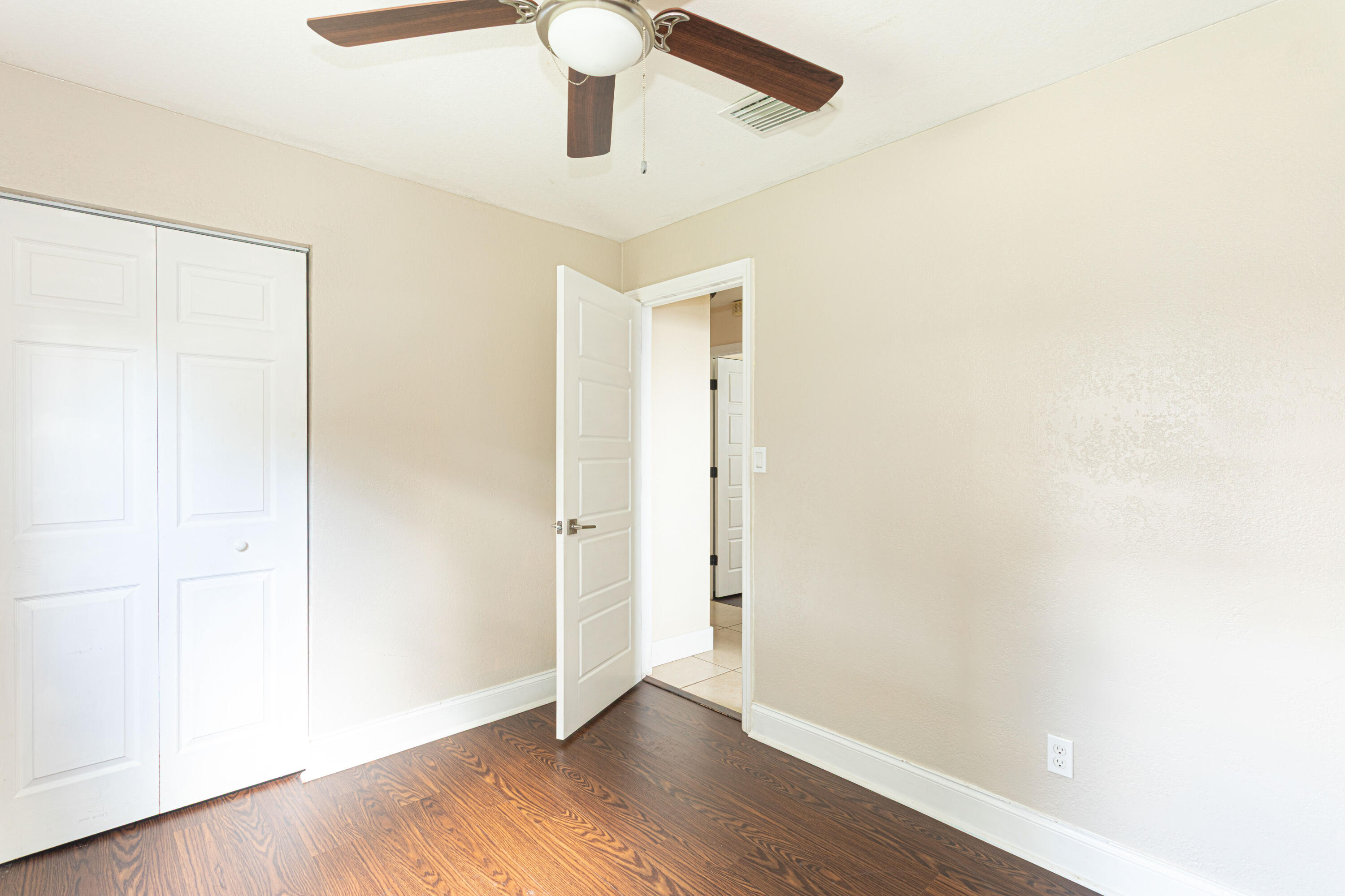 740 Aspen Road West Palm Beach, FL 33409 - Photo 17 of 34 a view of an empty room with wooden floor