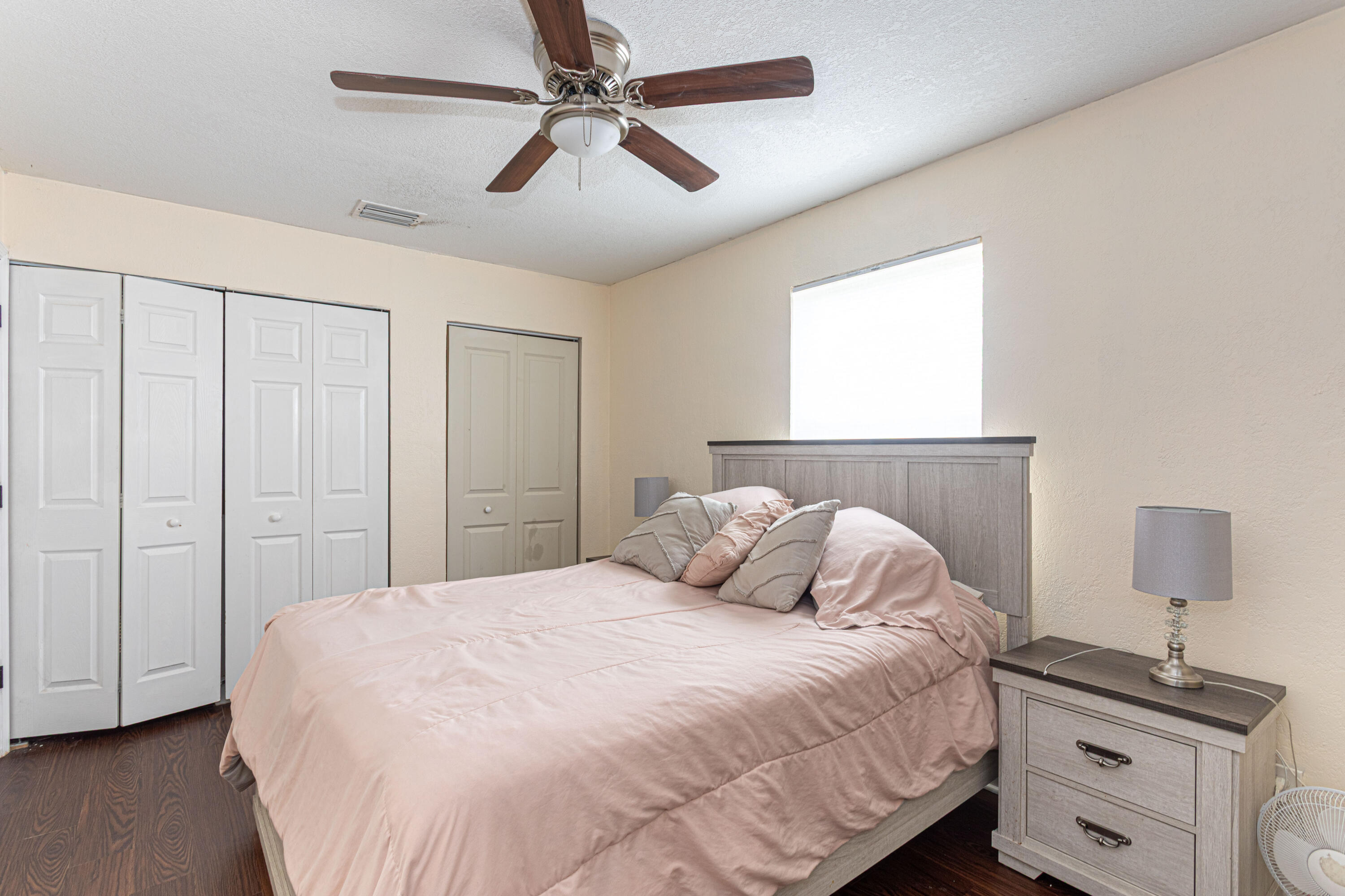 740 Aspen Road West Palm Beach, FL 33409 - Photo 19 of 34 a bedroom with a large bed and a chandelier