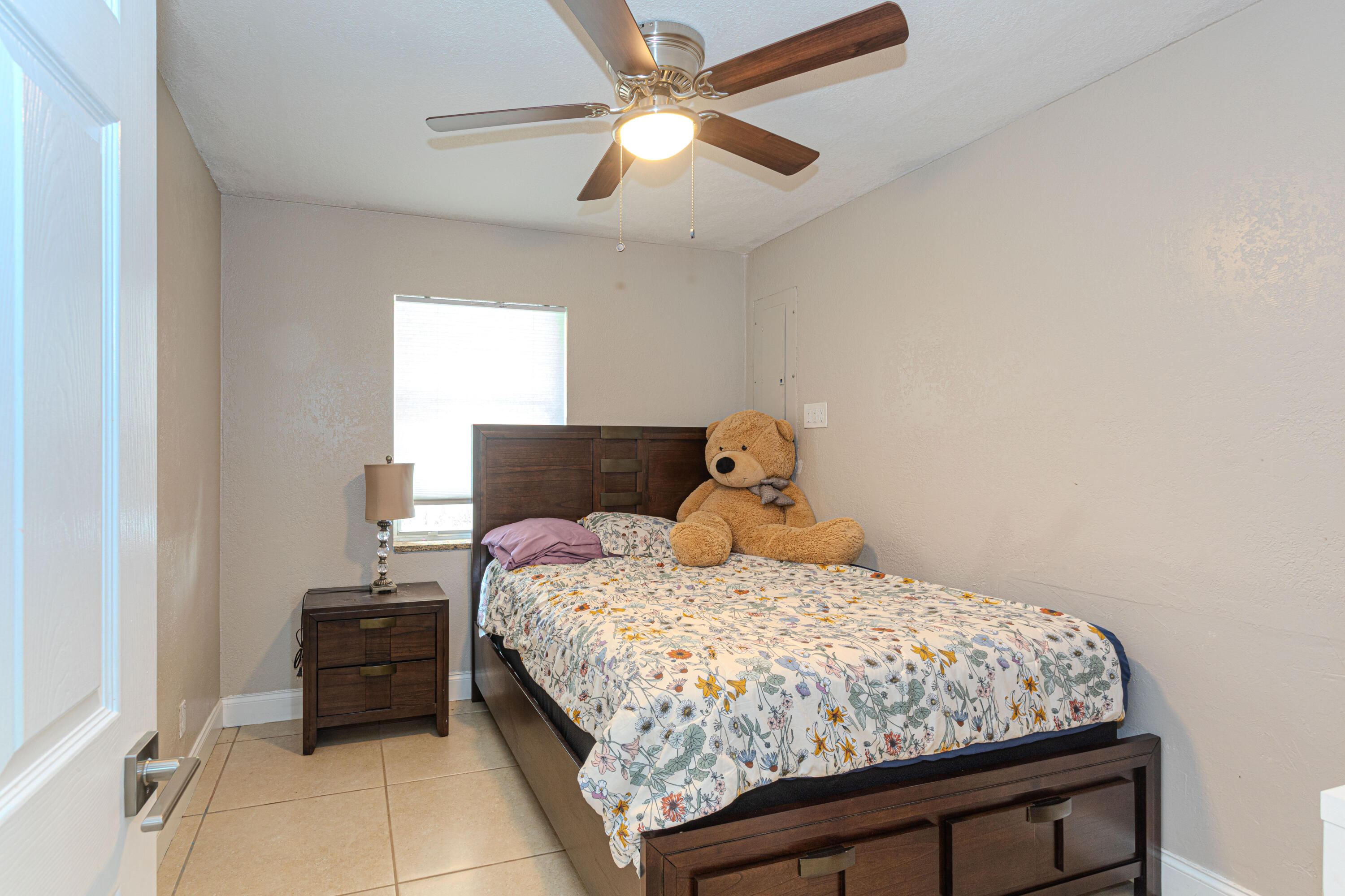 740 Aspen Road West Palm Beach, FL 33409 - Photo 20 of 34 a bedroom with a bed and a ceiling fan