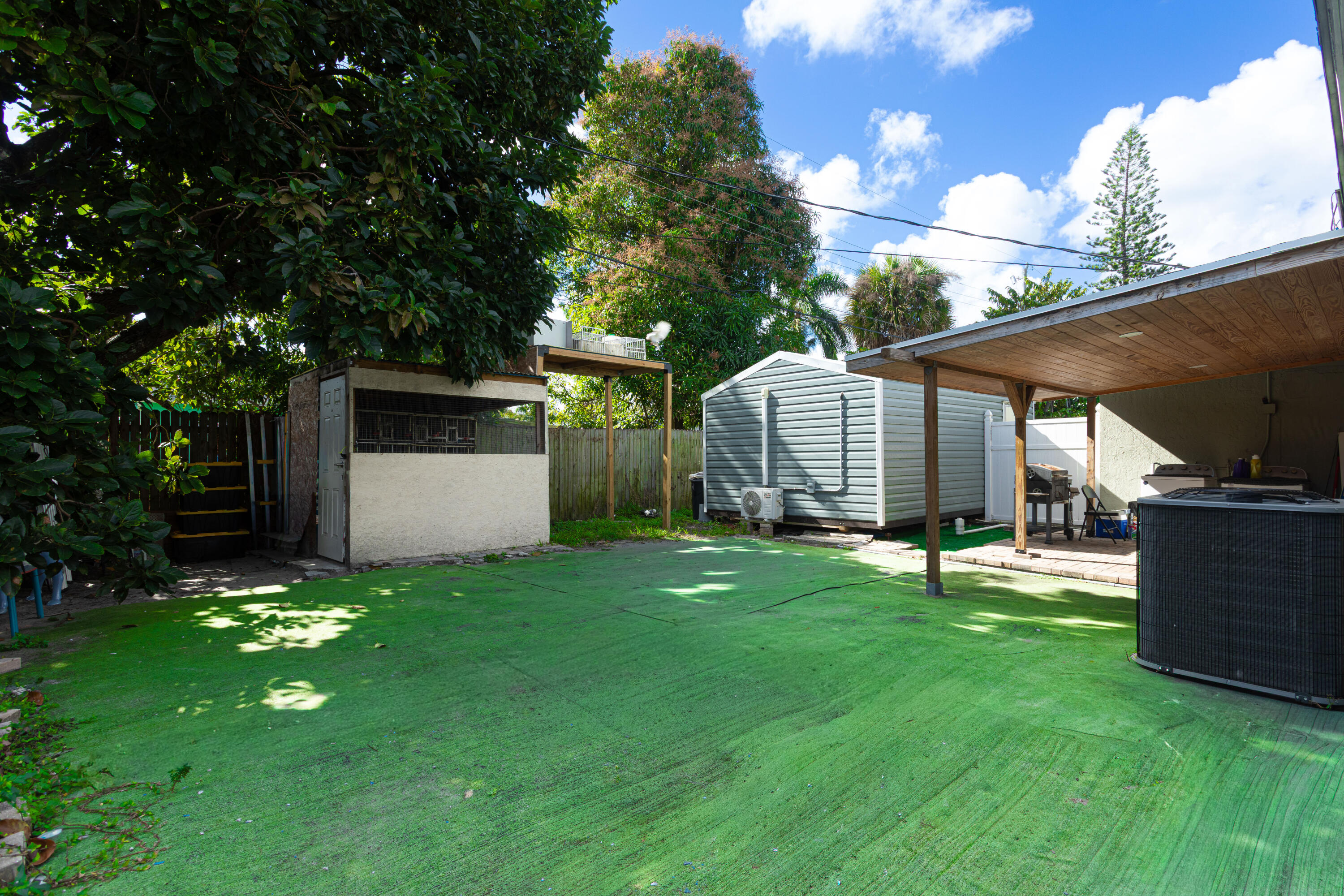 740 Aspen Road West Palm Beach, FL 33409 - Photo 25 of 34 a view of a backyard with a garden and tree