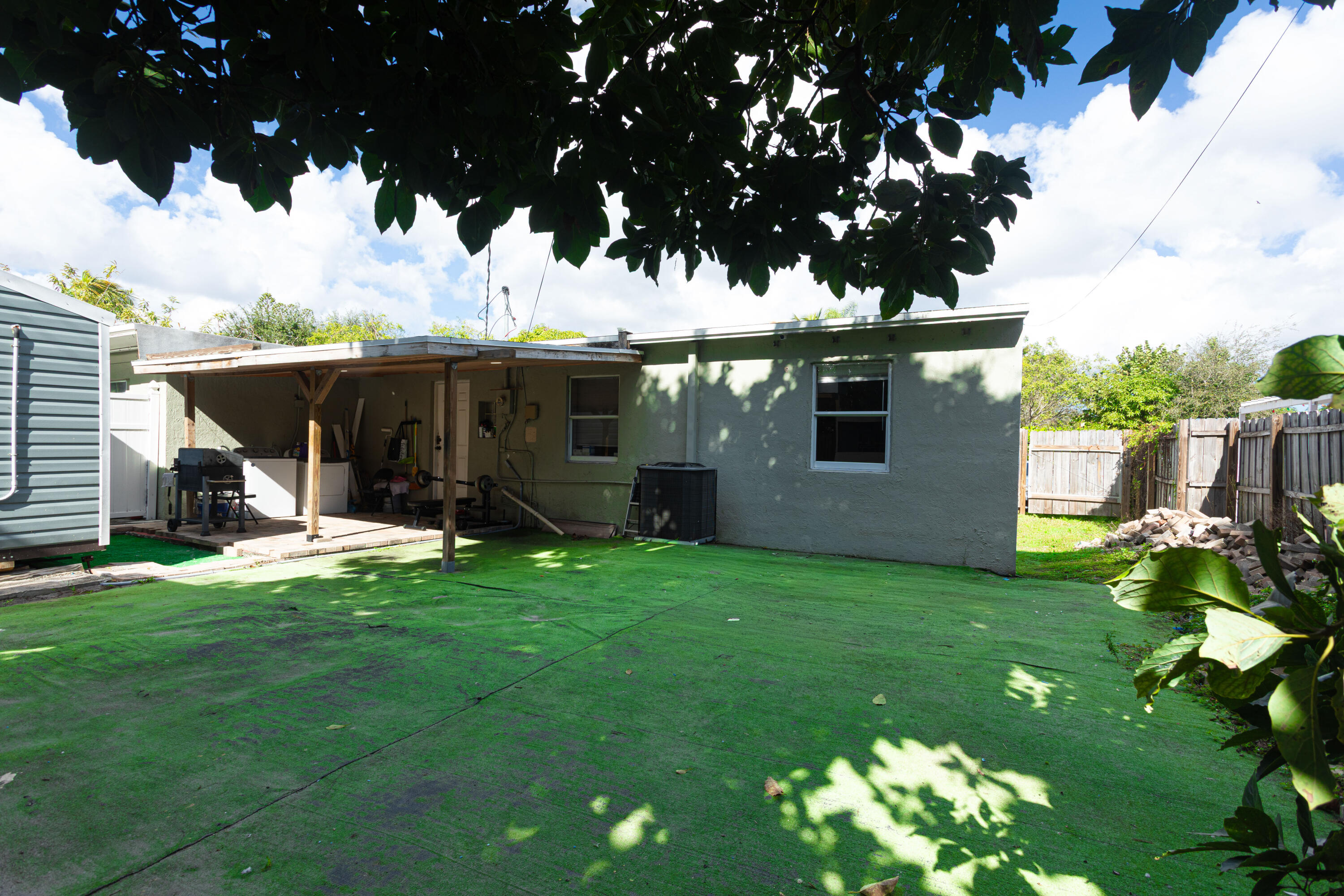 740 Aspen Road West Palm Beach, FL 33409 - Photo 28 of 34 a view of a house with backyard and sitting area