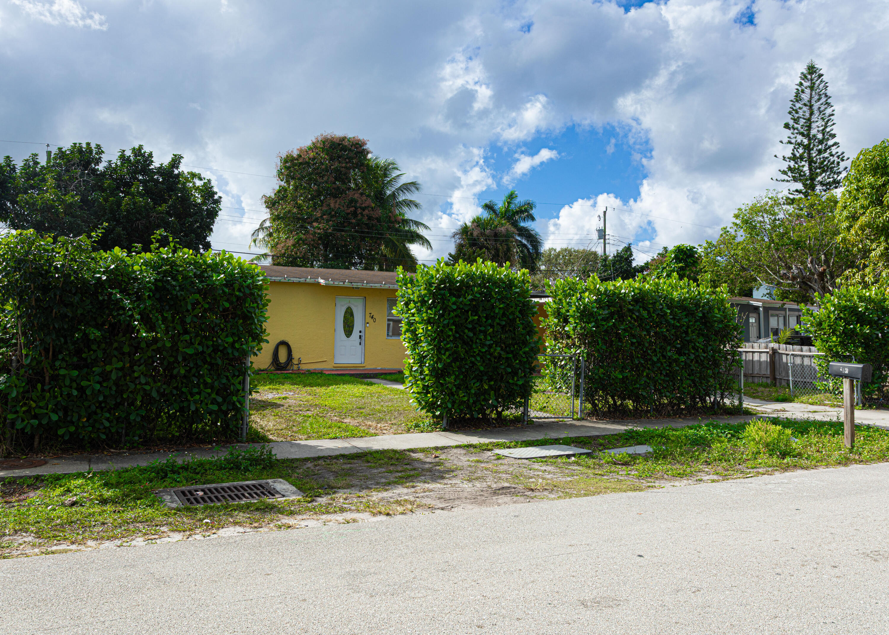 740 Aspen Road West Palm Beach, FL 33409 - Photo 3 of 34 a view of a house with a yard and a garage