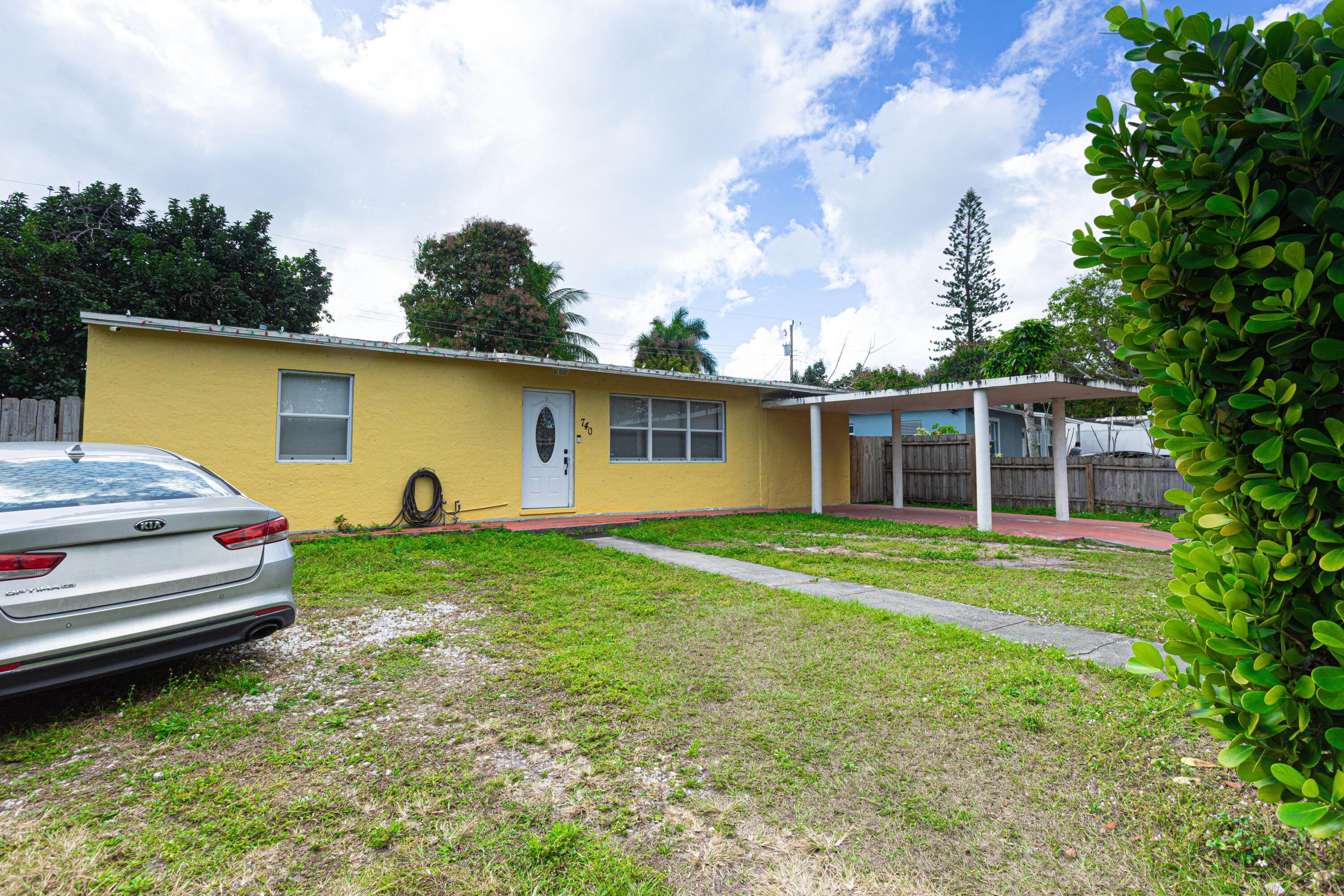 740 Aspen Road West Palm Beach, FL 33409 - Photo 7 of 34 a front view of a house with garden
