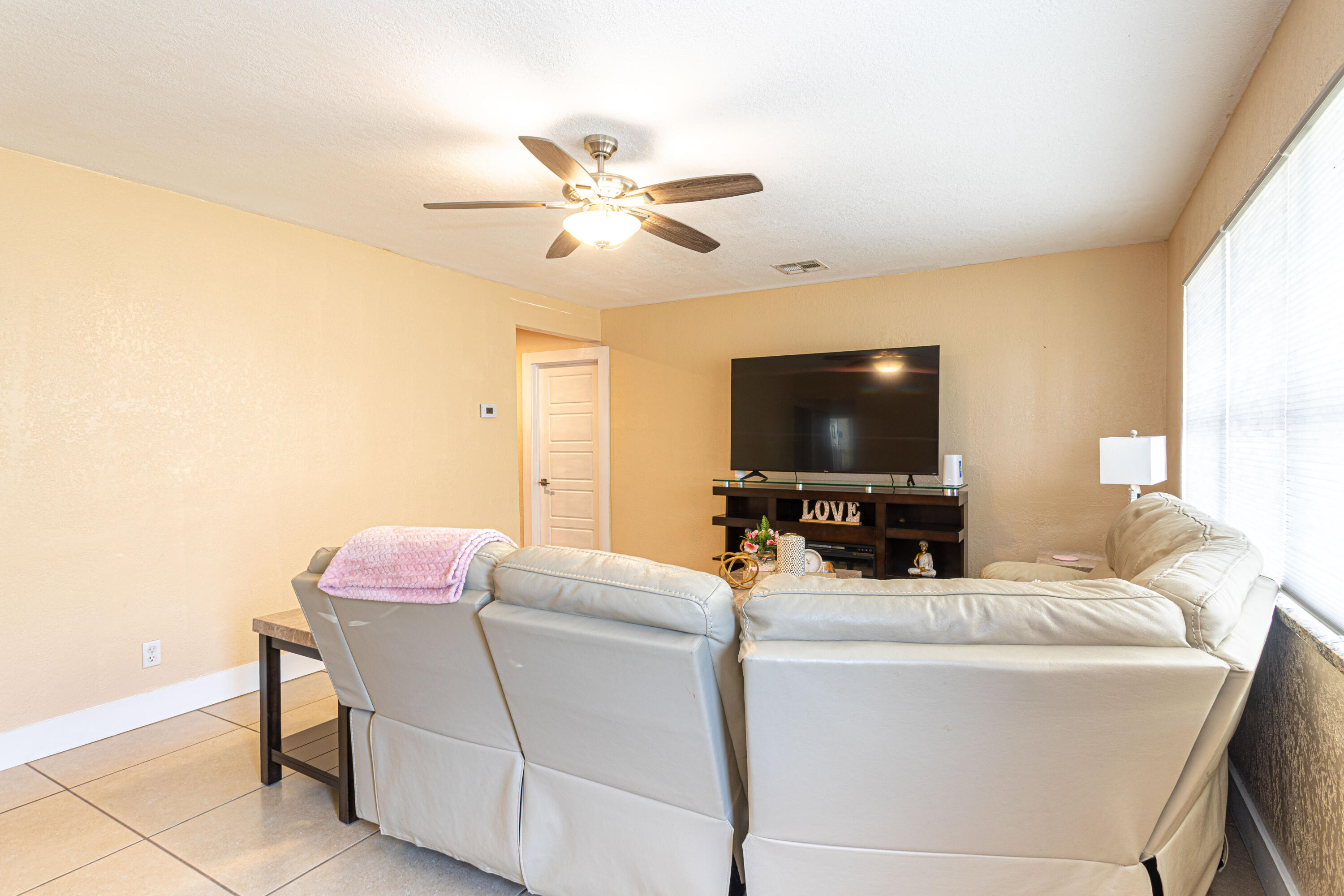 740 Aspen Road West Palm Beach, FL 33409 - Photo 10 of 34 a living room with furniture and a flat screen tv