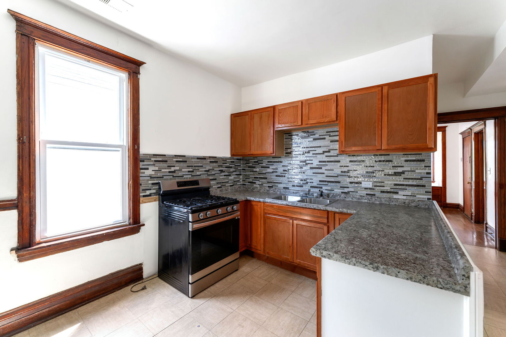 1921 North Pulaski Road, Unit 2 Chicago, IL 60639 - Photo 12 of 15 a kitchen with granite countertop stainless steel appliances and granite counter tops