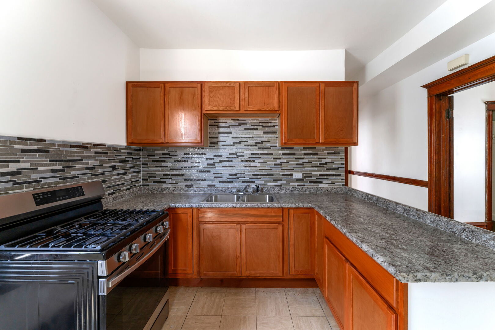 1921 North Pulaski Road, Unit 2 Chicago, IL 60639 - Photo 13 of 15 a kitchen with stainless steel appliances granite countertop a sink and a stove