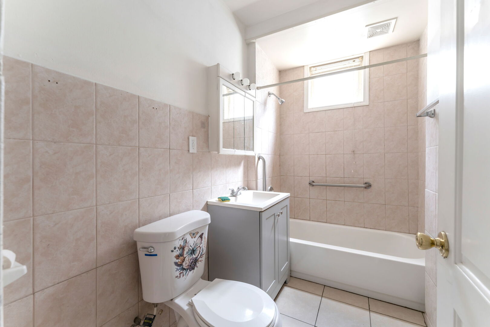 1921 North Pulaski Road, Unit 2 Chicago, IL 60639 - Photo 10 of 15 a bathroom with a sink a toilet a mirror and a bathtub