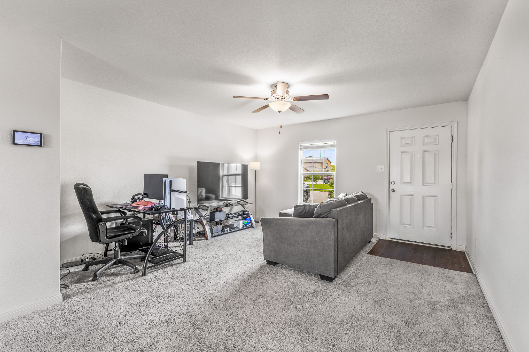 304 Hyacinth Way, Unit #7K Jarrell, TX 76537 - Photo 5 of 26 A versatile living space with a soft carpet, perfect for work or leisure.