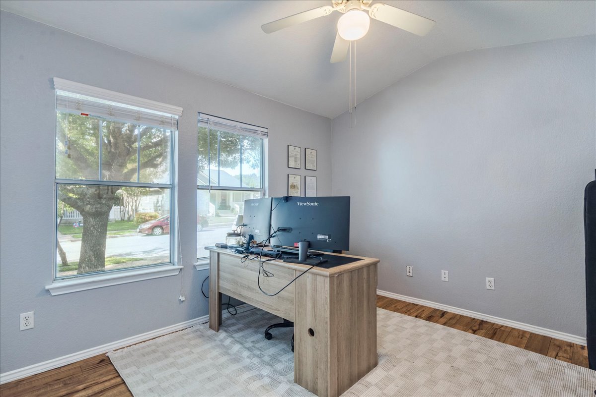 175 Wetzel Kyle, TX 78640 - Photo 22 of 27 A versatile home office offers abundant natural light and rich wood flooring.