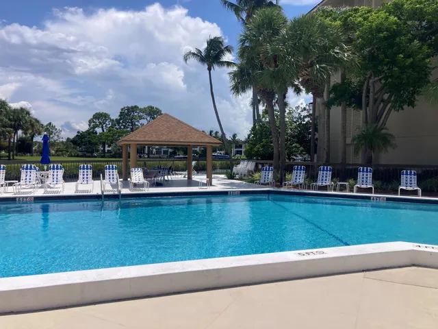 a view of swimming pool with outdoor seating and trees