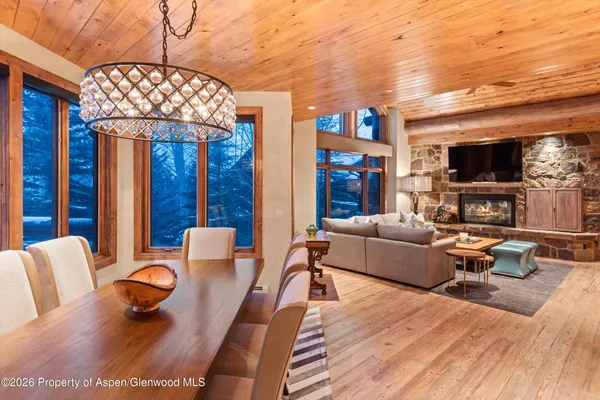 a dining hall with stainless steel appliances granite countertop a stove and a dining table view