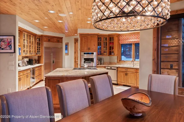 a kitchen with granite countertop a sink stove and refrigerator