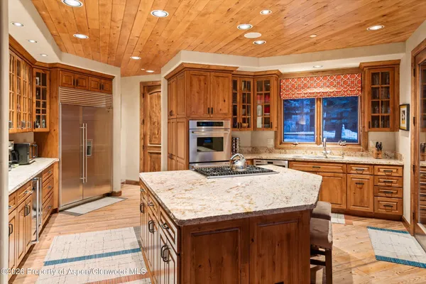 a living room with furniture a rug and a lamp