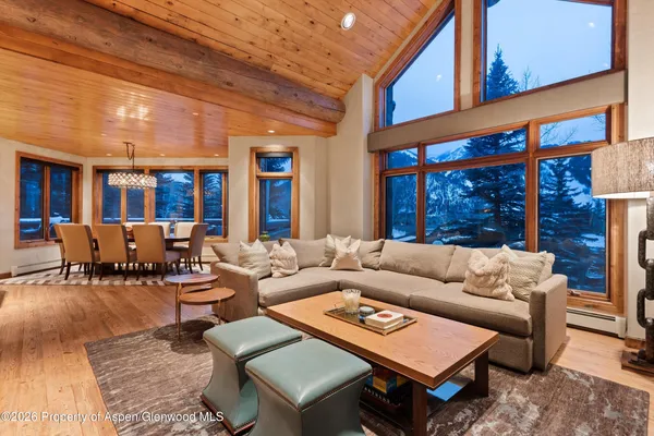 a living room with patio furniture and a large window