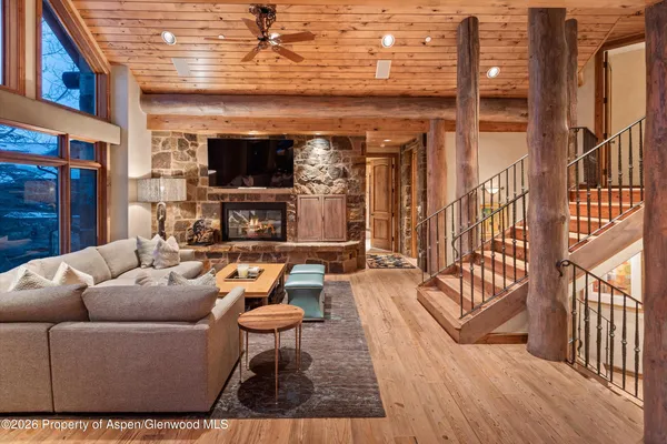 a living room with furniture a flat screen tv and a fireplace