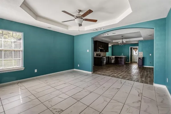 an empty room with closet and windows