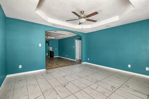 a view of a livingroom with a ceiling fan and window