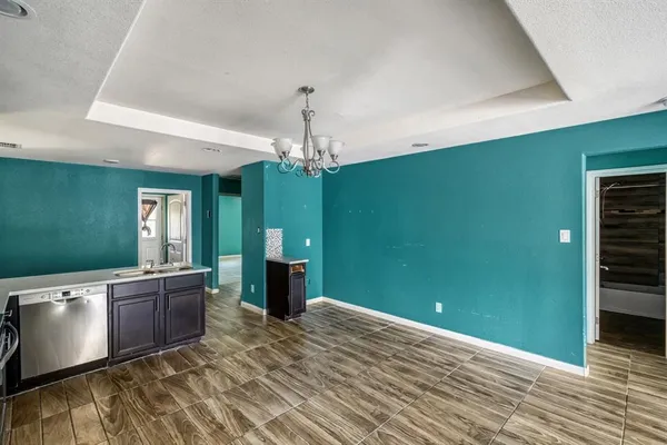a view of a room with kitchen window and wooden floor