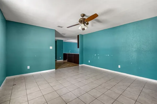 a view of a room with a ceiling fan