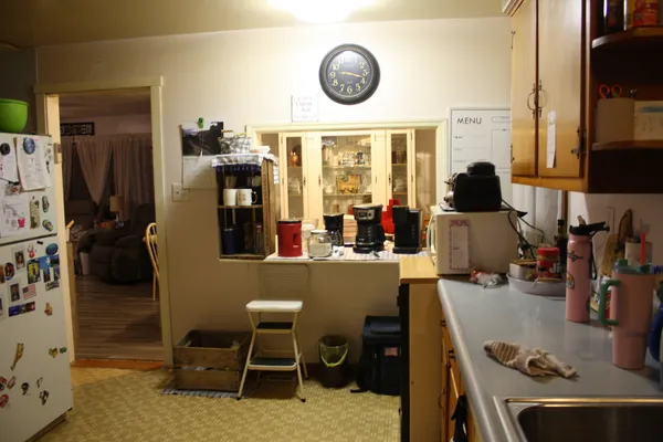 a kitchen with sink a window and cabinets
