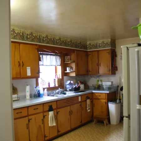 a kitchen with a sink appliances and cabinets