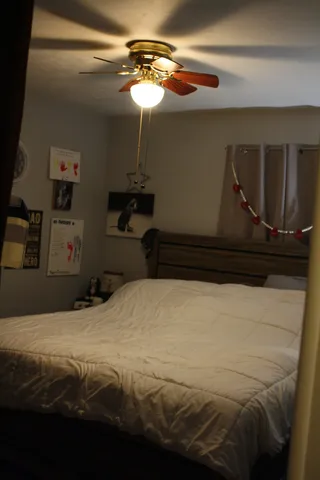 a bedroom with a bed and a mirror