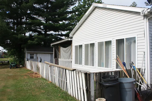 a view of a house with backyard and deck