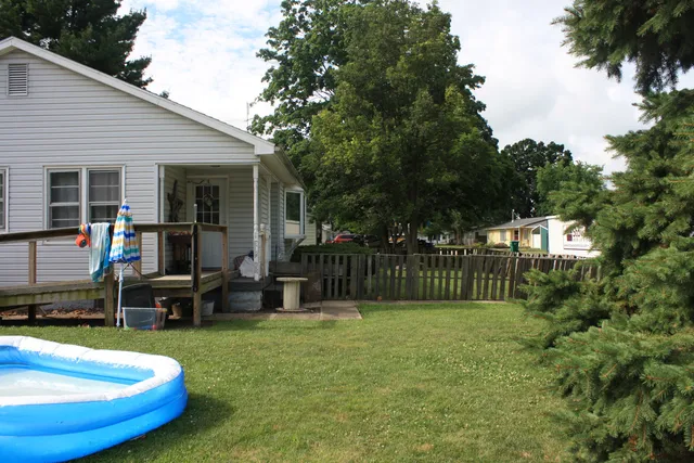 a view of a house with swimming pool and sitting area