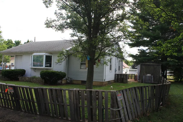 a front view of house with yard and green space