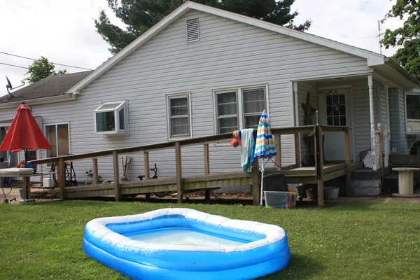 a view of house with a swimming pool