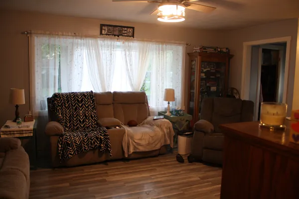a living room with furniture window and a flat screen tv